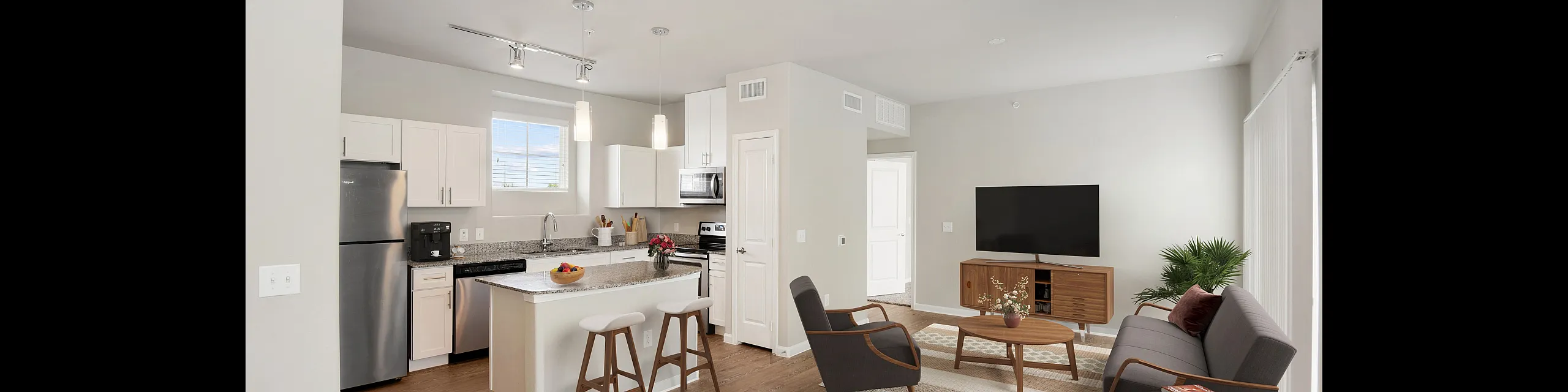 Modern open-concept living space with a sleek kitchen island, stylish living room, and contemporary decor. The perfect blend of comfort and elegance.