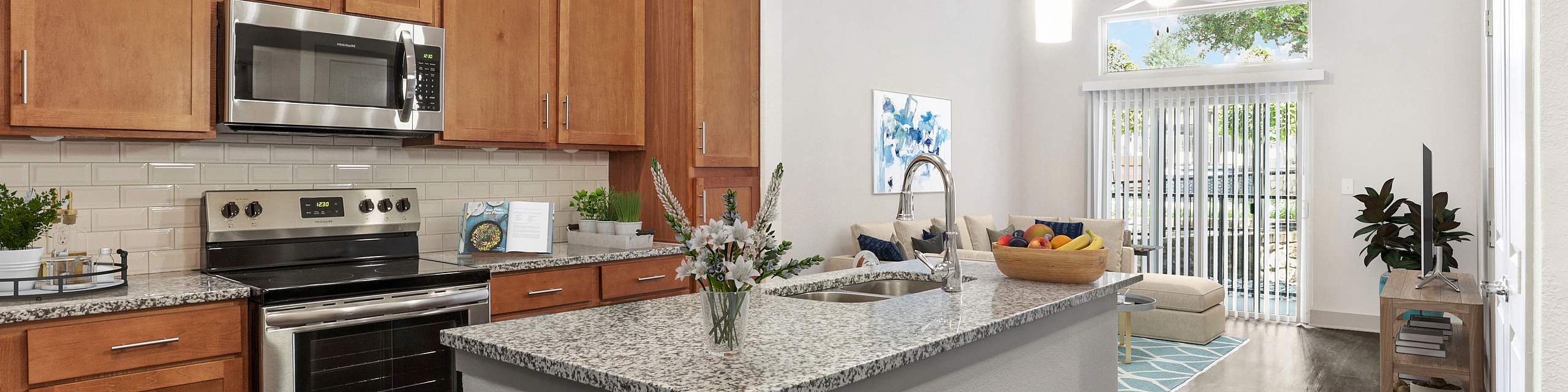 Contemporary open-plan kitchen and living room with sleek granite countertops, stainless steel appliances, and inviting natural light.