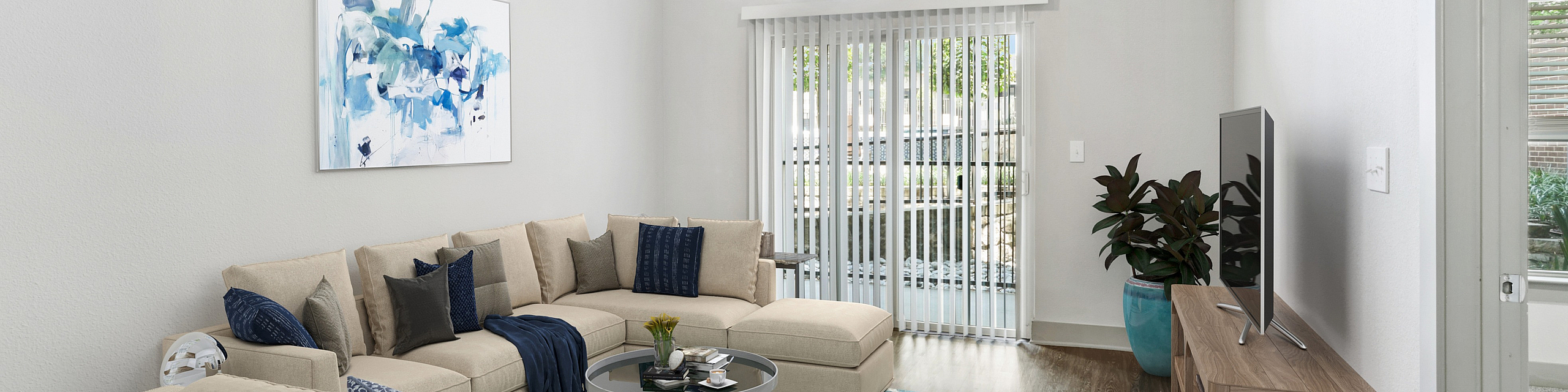 Bright and modern living room featuring a stylish sectional sofa, elegant decor, and natural light through large windows and glass doors.