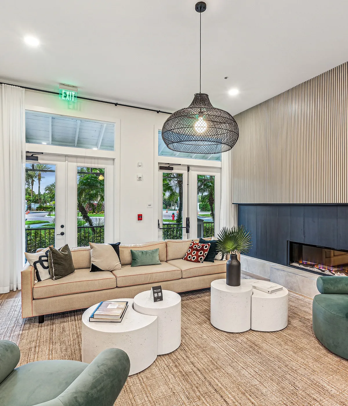 Chic living space featuring modern furniture with plush seating, artistic decor, and a sleek fireplace for a cozy ambiance.