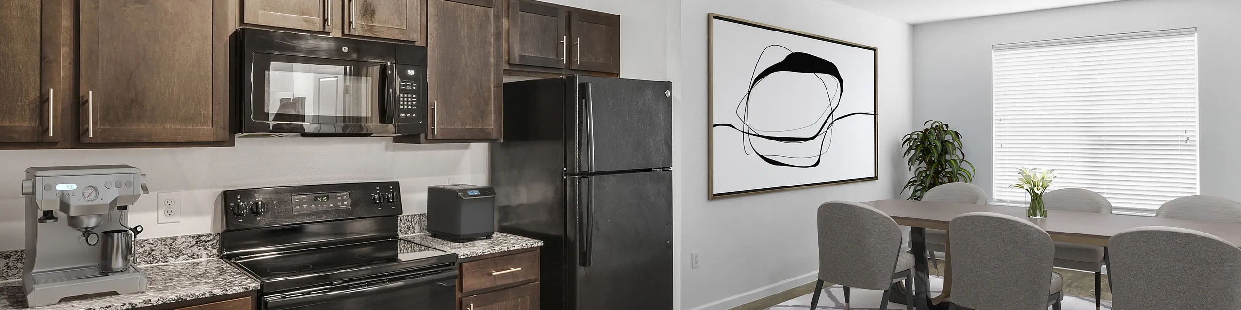Modern kitchen with dark wood cabinets, sleek appliances, and a spacious dining area filled with natural light.