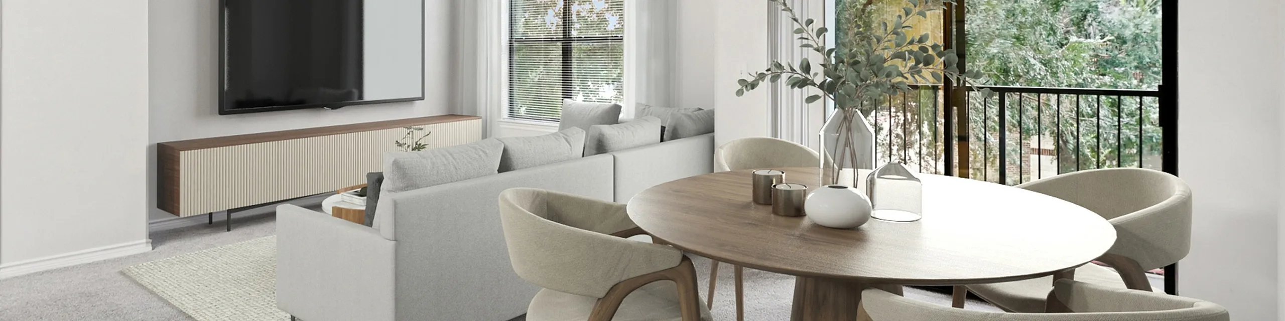Bright and airy living room with chic modern furniture, large TV, and dining area, offering serene green views through expansive windows.