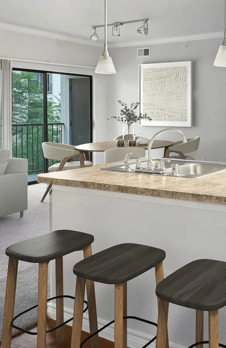 Modern open-concept kitchen and dining area featuring warm wood cabinets, sleek black appliances, and a stylish breakfast bar with seating.
