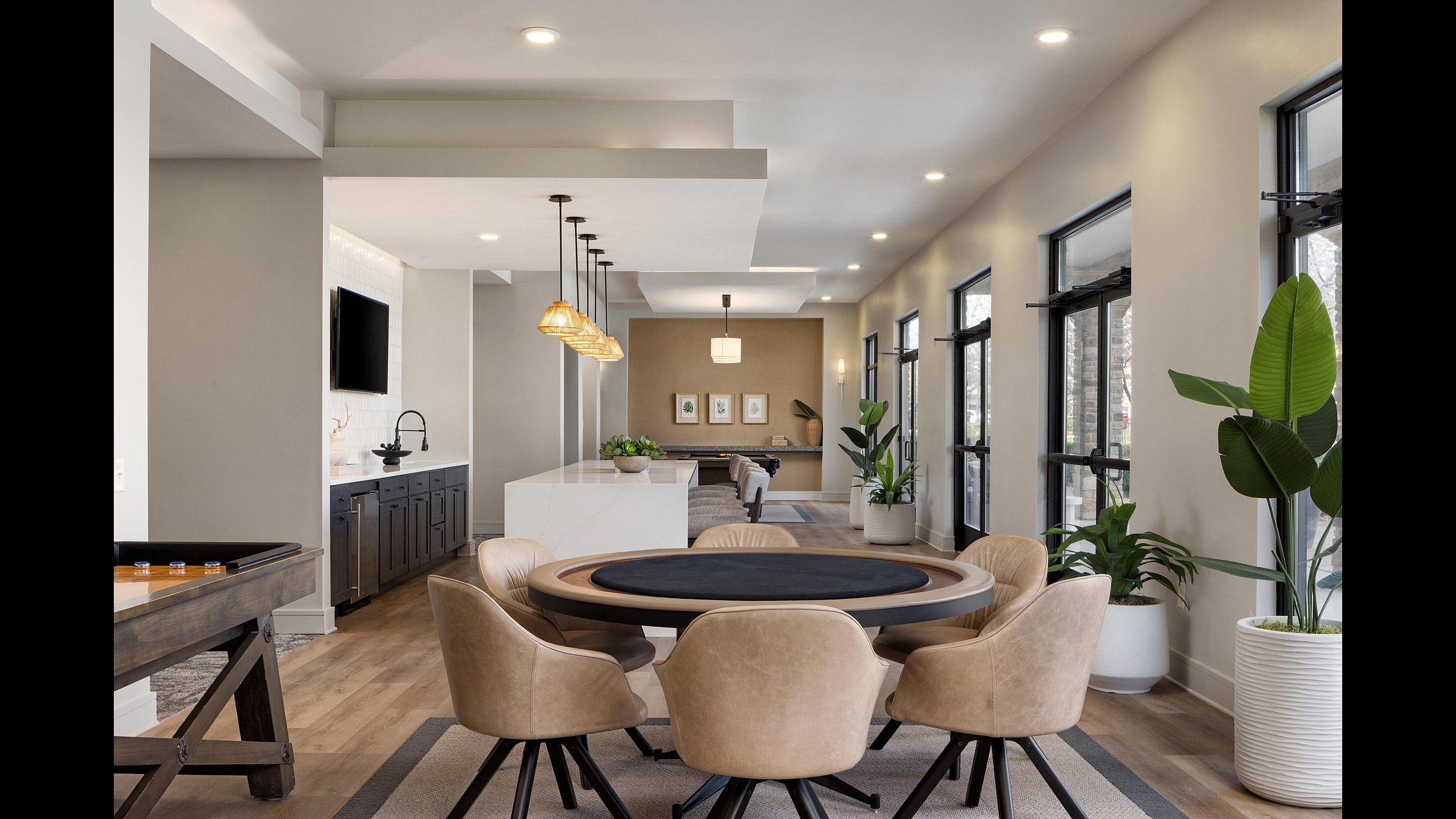 Luxurious apartment interior featuring an elegant dining area, contemporary art, and natural light from large windows.