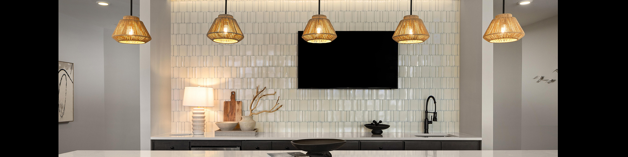Modern living room with stylish decor, featuring a sleek leather sofa, elegant wall patterns, and chic pendant lighting.