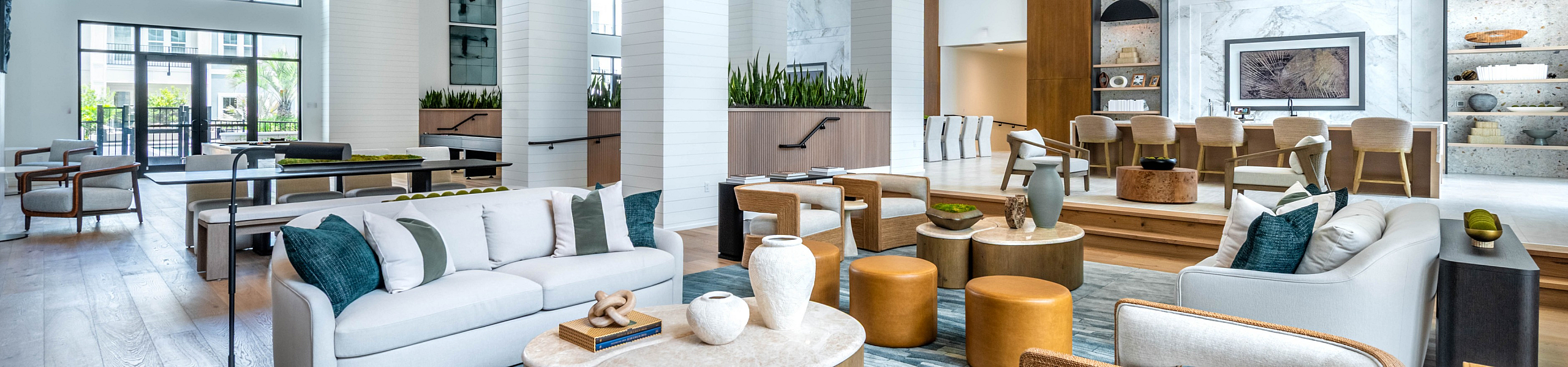 Luxurious open-concept living area featuring elegant modern decor, plush seating, and expansive windows with natural light.