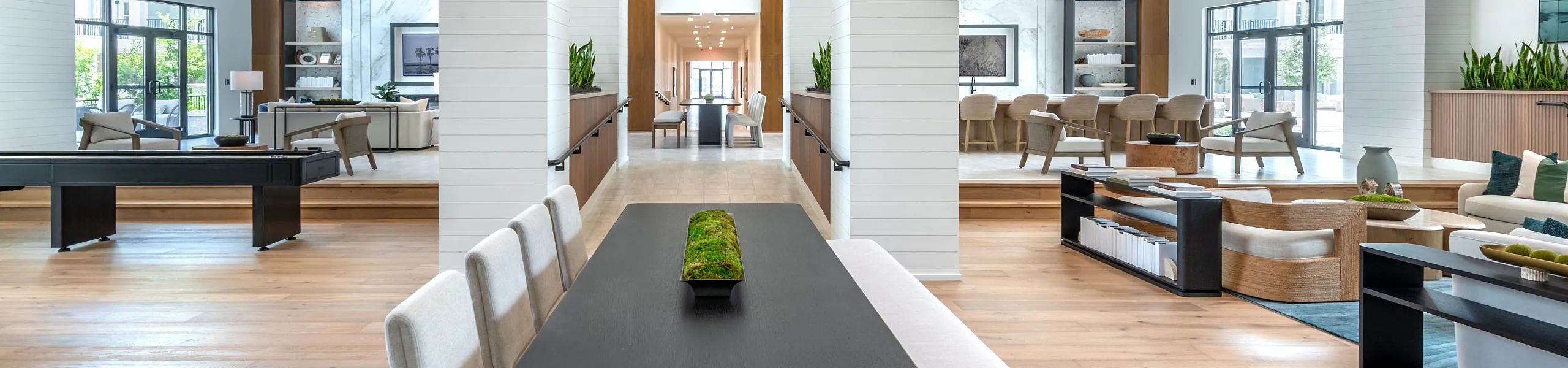 Luxurious open-concept living space with elegant wooden beams, modern dining area, and abundant natural light.