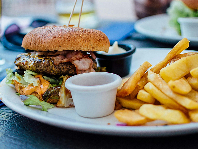 Burgers and Fries on a white plate from a local Burger and Taphouse