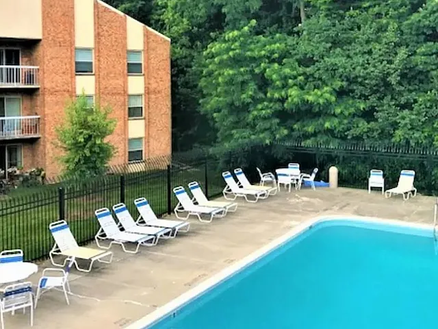 Creekside Village swimming pool with sundeck and chairs