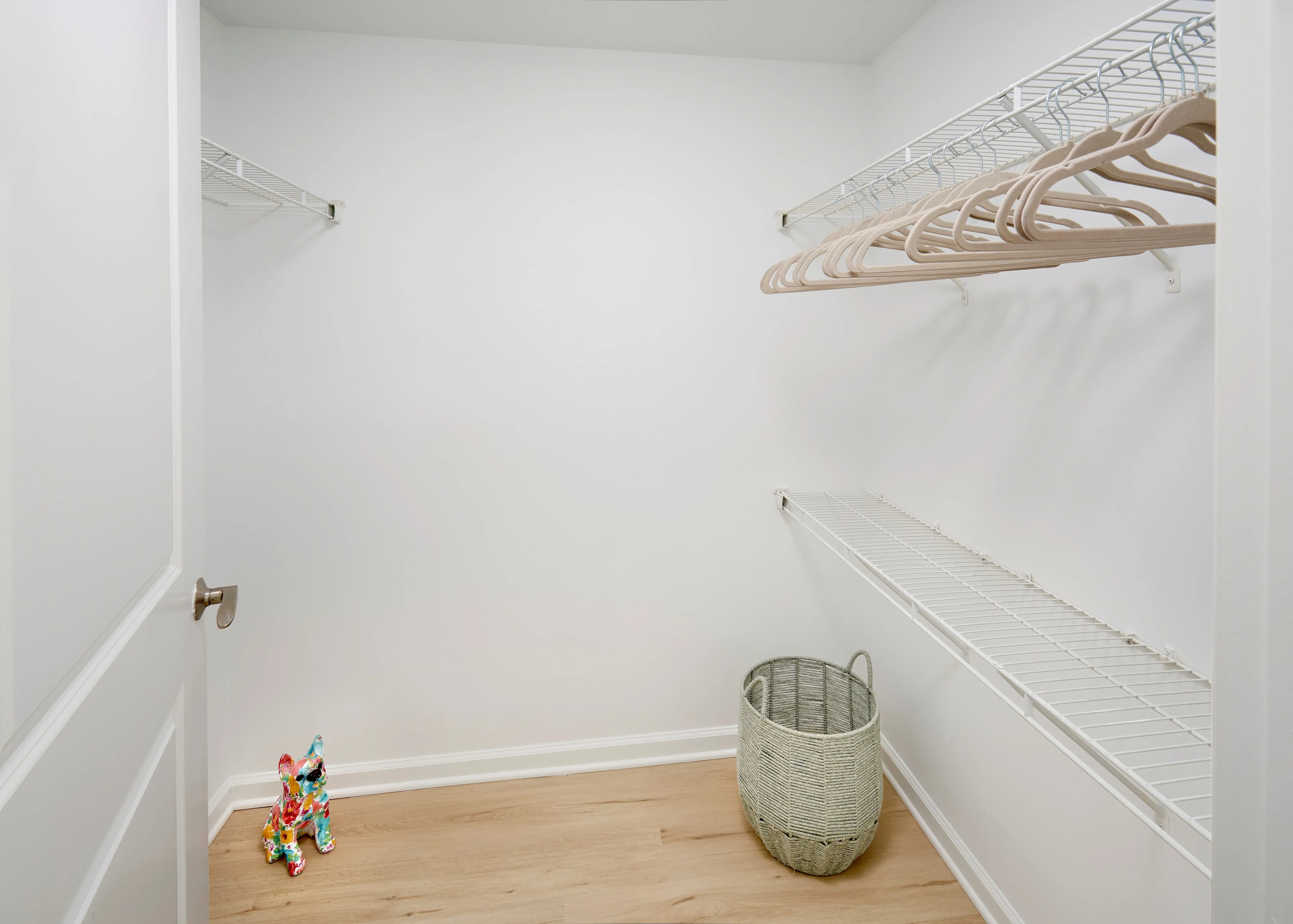 Ellington One Bedroom walk-in closet featuring new wood-style vinyl plank flooring | Meridian at Grosvenor Station | Luxury North Bethesda MD Apartments | Luxury Rockville MD Apartments