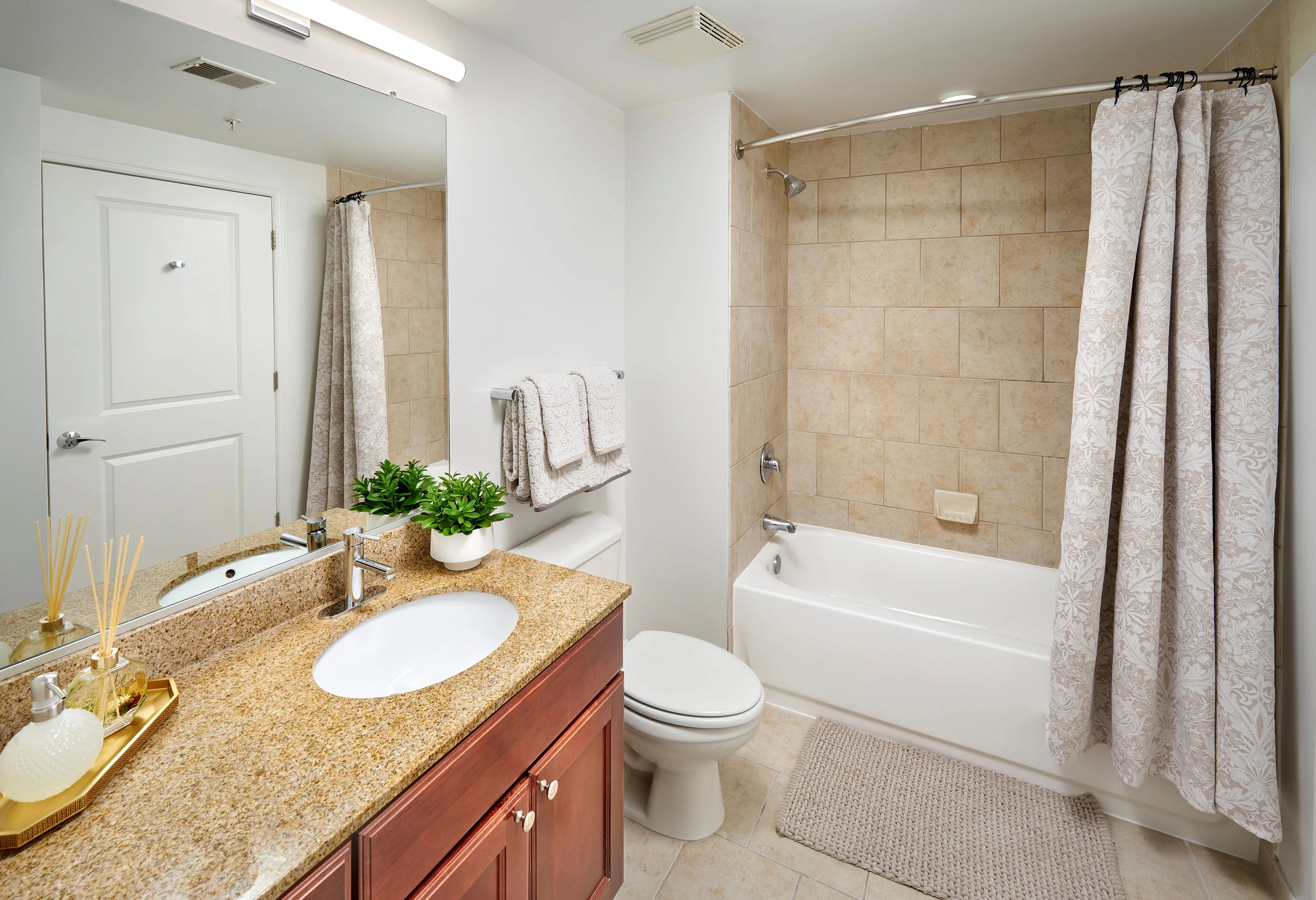 Renovated Ellington One Bedroom bathroom with granite vanity, custom cabinets, and updated lighting and fixtures | Meridian at Grosvenor Station | Luxury North Bethesda MD Apartments | Luxury Rockville MD Apartments
