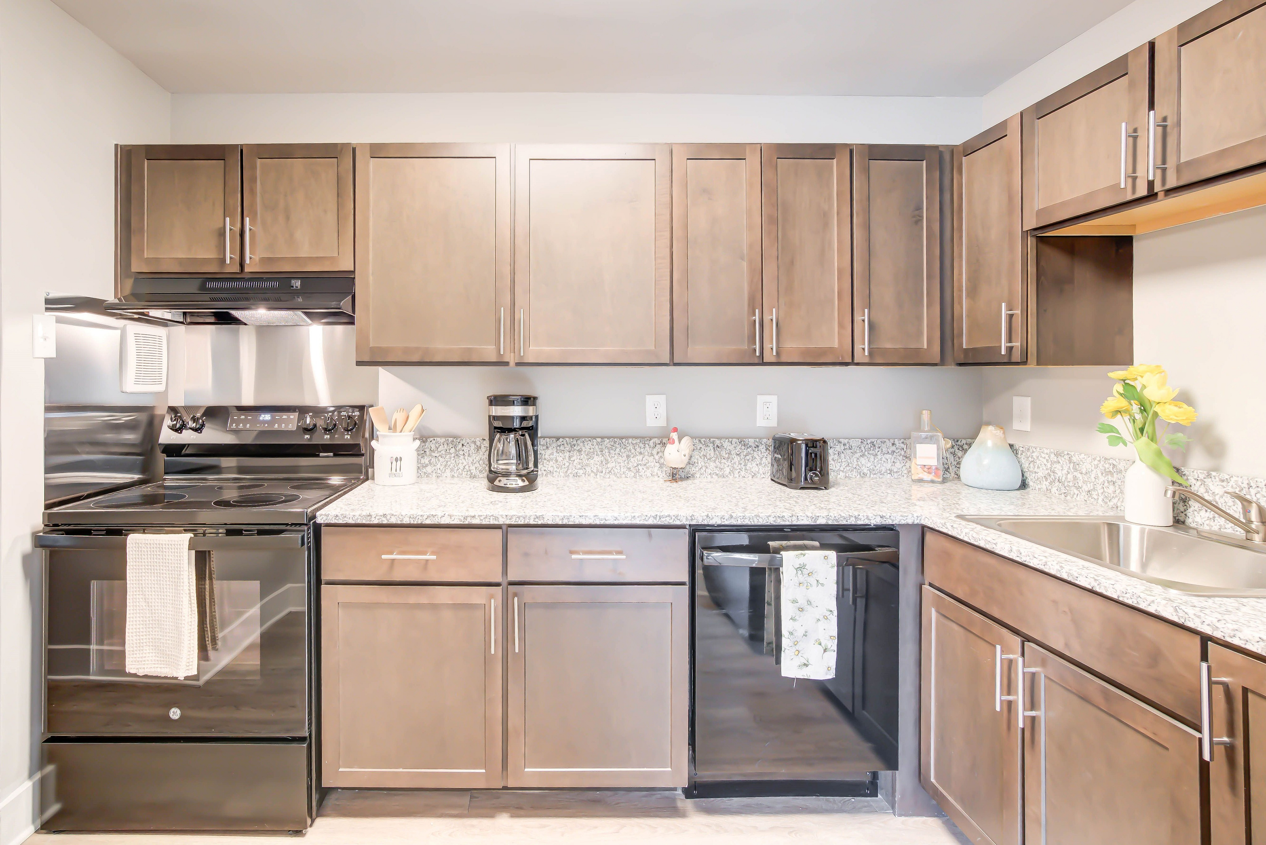 Image of Newly Renovated Kitchen With Granite Countertop, Wood-Style Flooring & Custom Cabinetry | Creekside Village | Creekside Village Apartments | Affordable Alexandria, VA Apartments | Affordable Fairfax County Apartments
