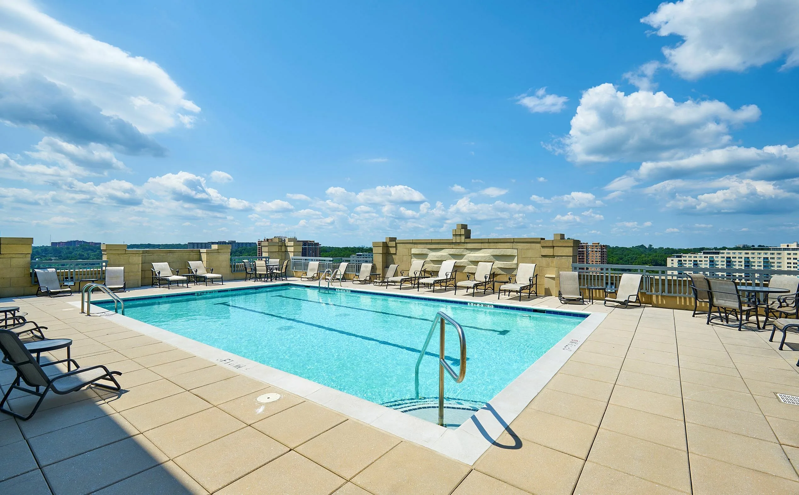 Relax at the rooftop swimming pool with two marked lap lanes and expansive sundeck at Meridian at Grosvenor Station, offering a luxury outdoor oasis with panoramic views of North Bethesda and easy access to the nearby Grosvenor-Strathmore | Luxury North Bethesda MD Apartments | Luxury Rockville Apartments