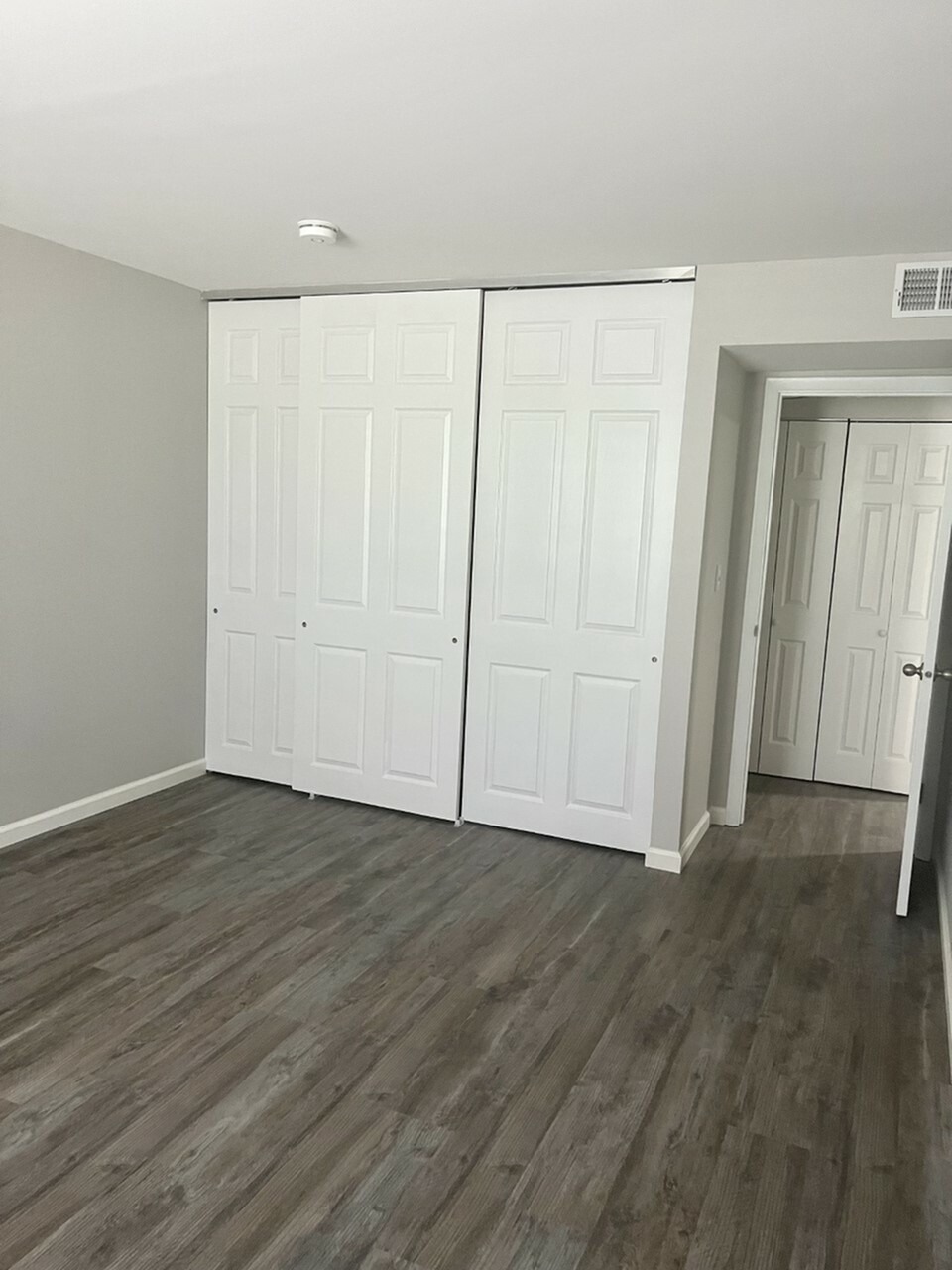 Bedroom Closet with white pannel doors