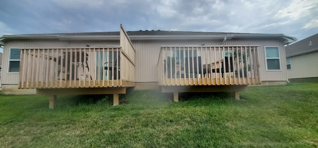 Enclosed Deck with a view of green lawn and a tranquil sky.