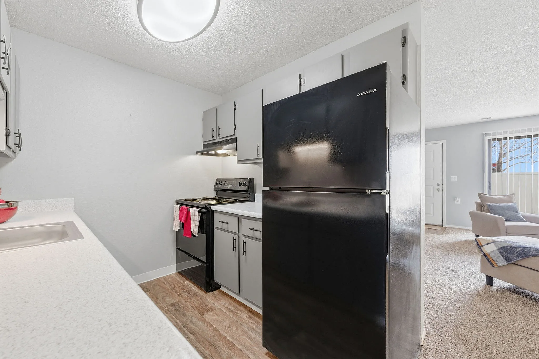 Contemporary kitchen with sleek cabinets, modern appliances, and an inviting open layout leading into a cozy living area.