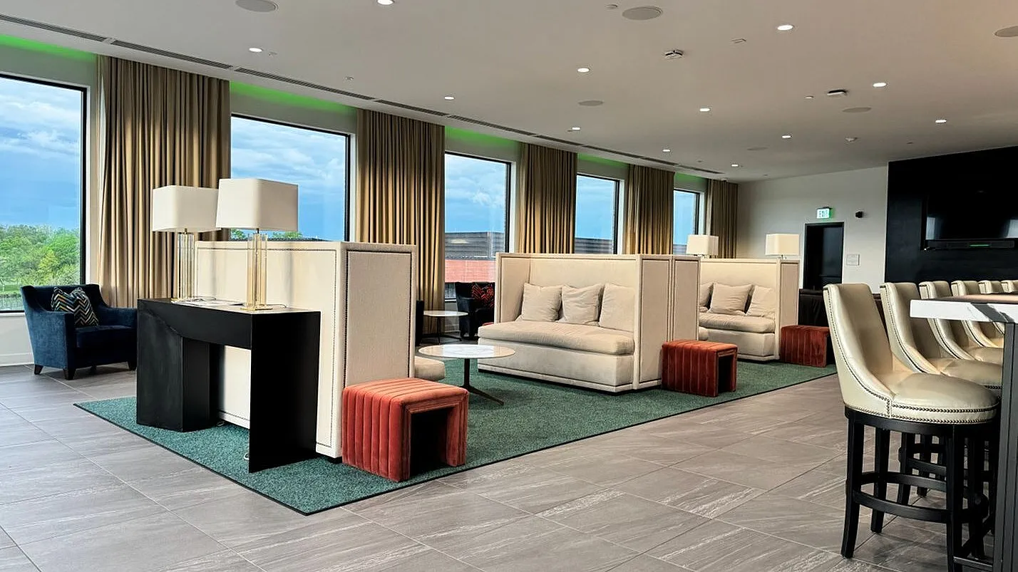 Elegant lounge with modern sofas, stylish lamps, and large windows offering scenic views, perfect for relaxation and social gatherings.