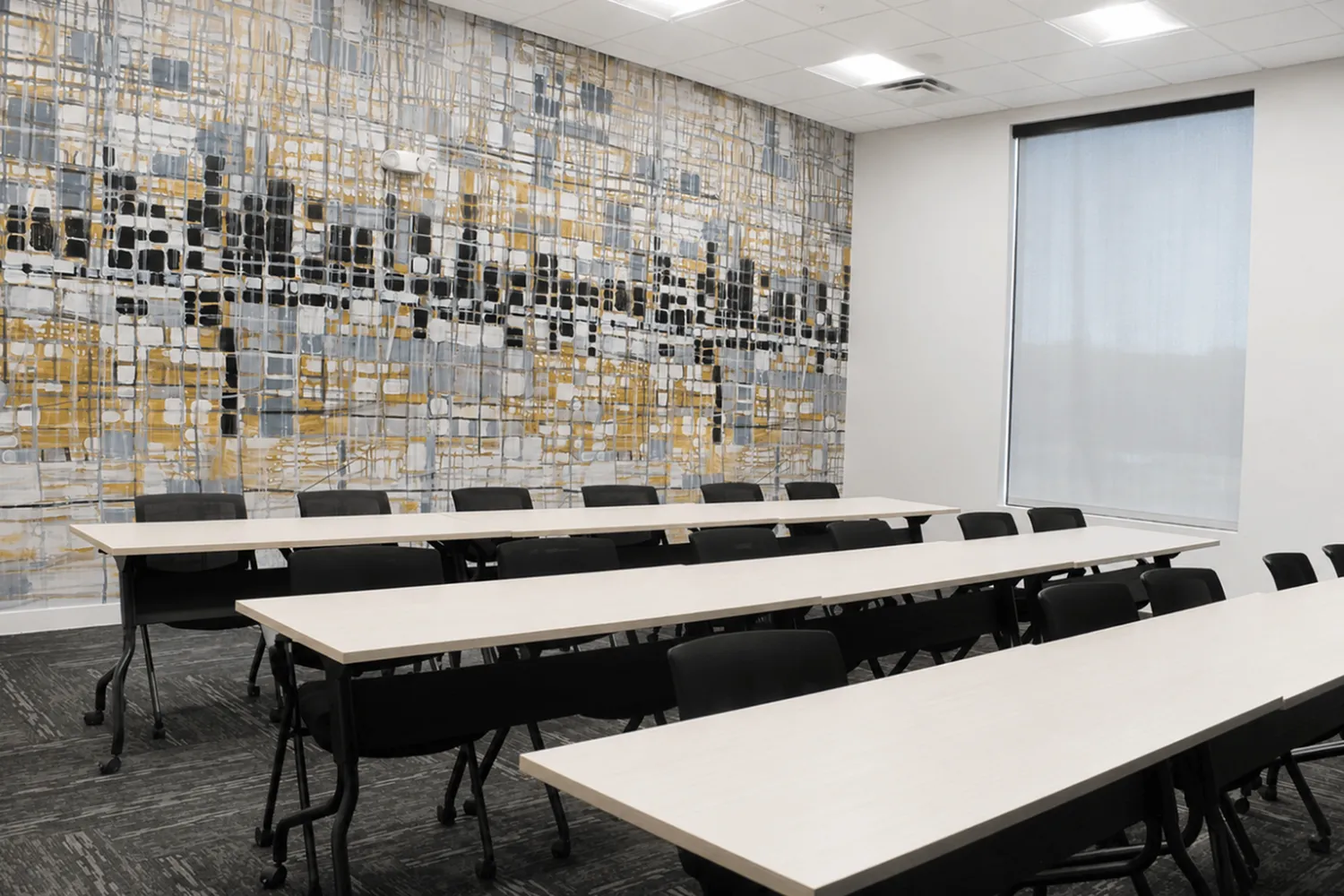 Modern and spacious conference room with elegant abstract mural and natural lighting, ideal for productive meetings and seminars.