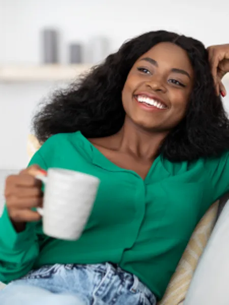 Happy Black Woman having Coffee