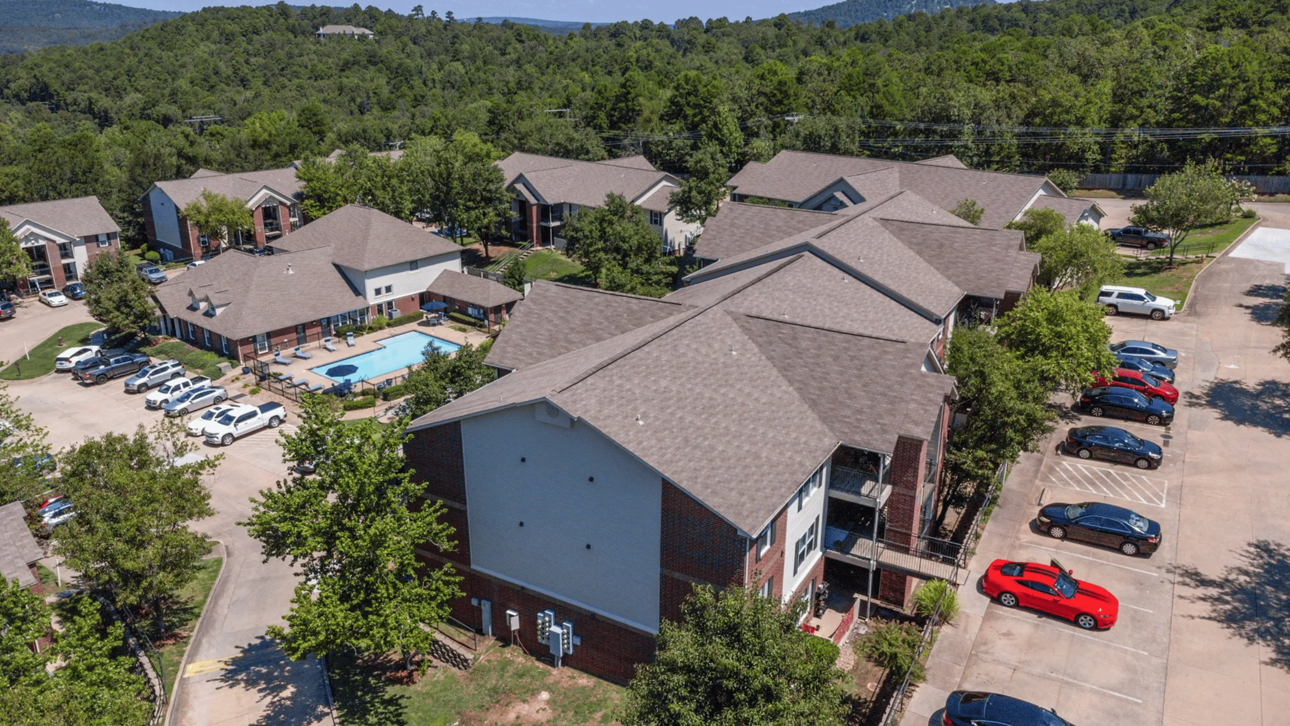 overhead of property showing buildings, pool, and surrounding mountains