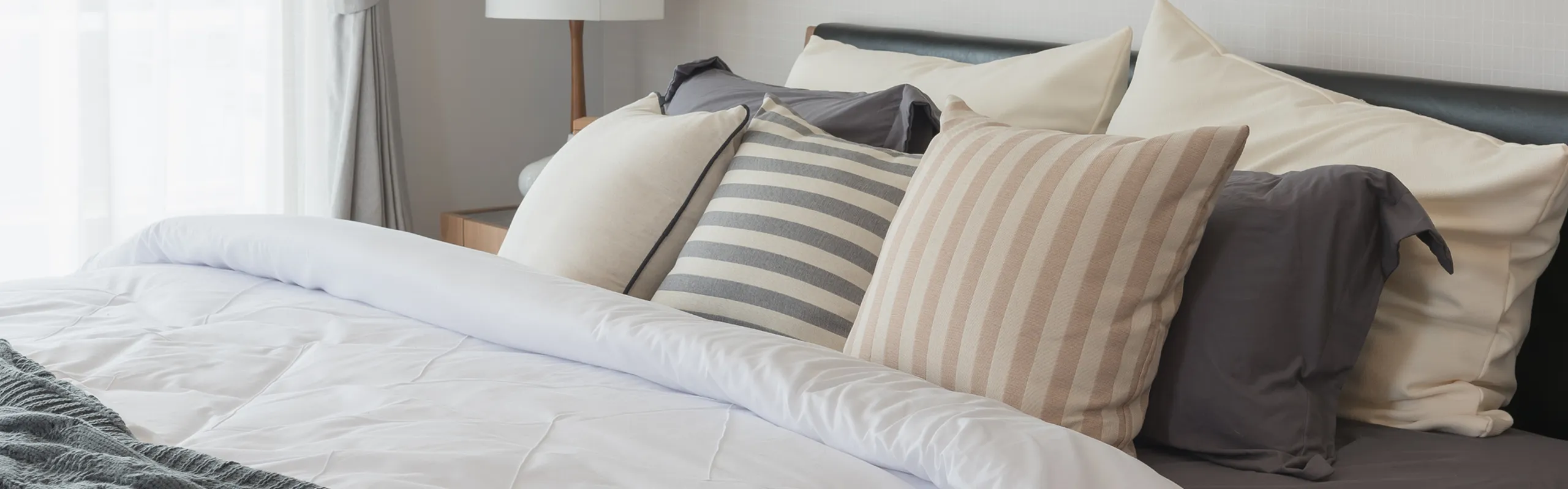 bed with a lot of pillows