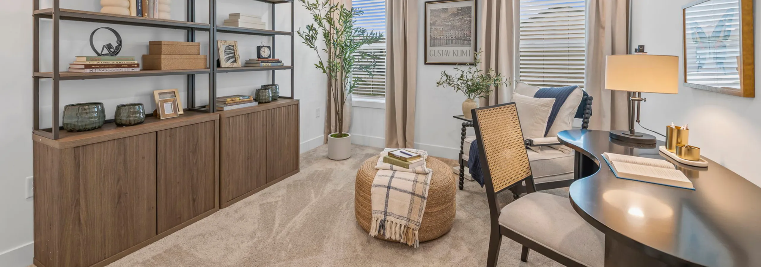 Charming home office with stylish wooden shelving, cozy seating, and warm lighting, perfect for productivity and relaxation.