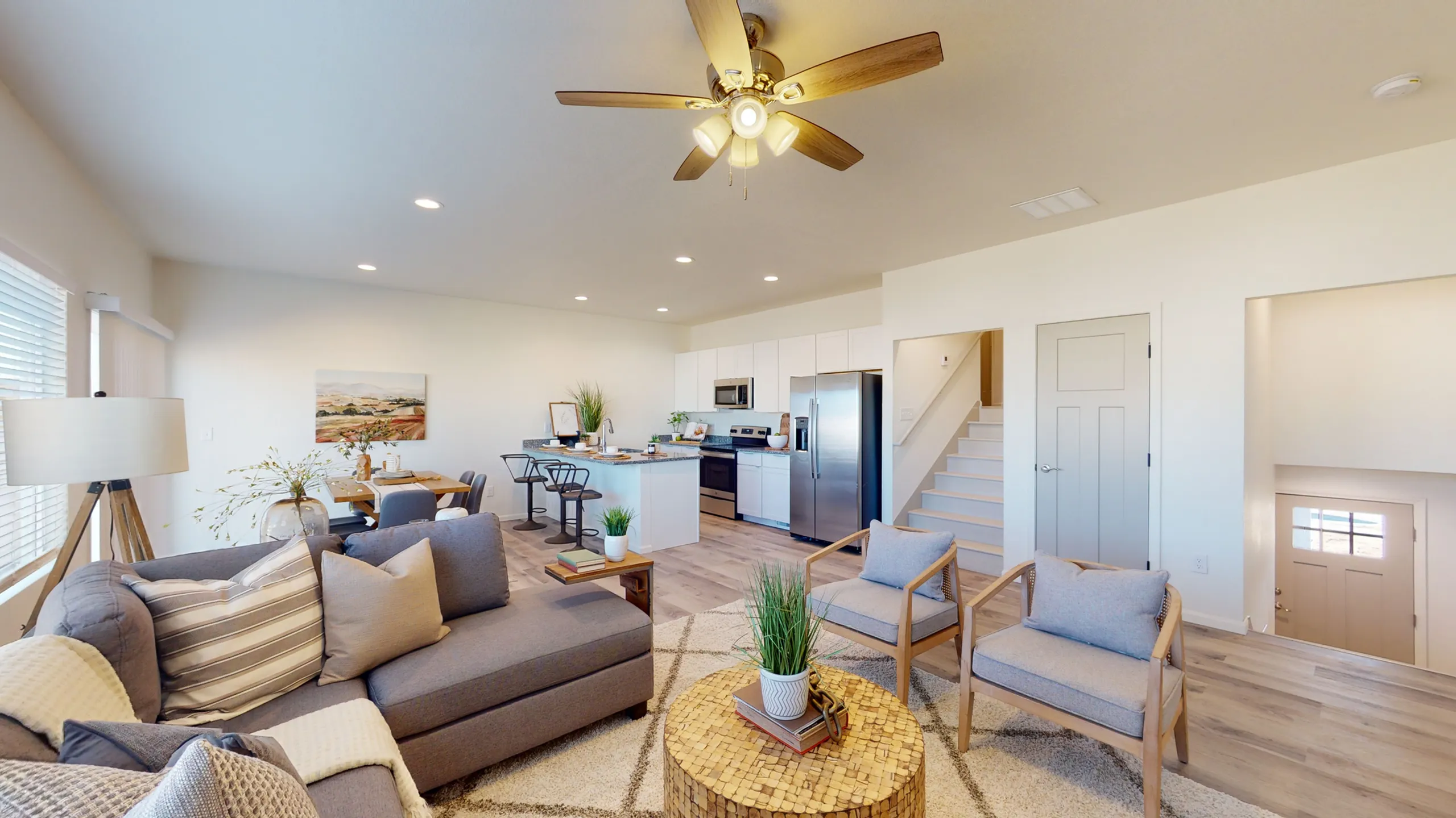 Bright and inviting open-concept living space with modern kitchen and stylish decor, perfect for relaxation and entertaining.