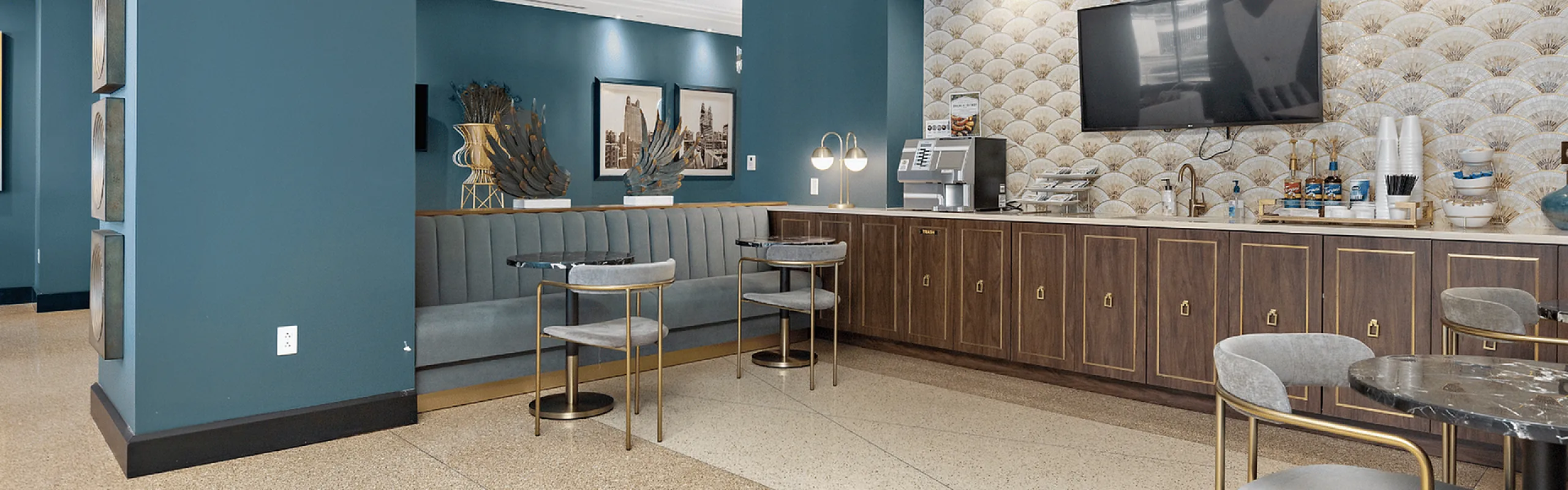 Chic apartment lounge featuring modern d&eacute;cor, elegant seating, and a stylish coffee bar area.