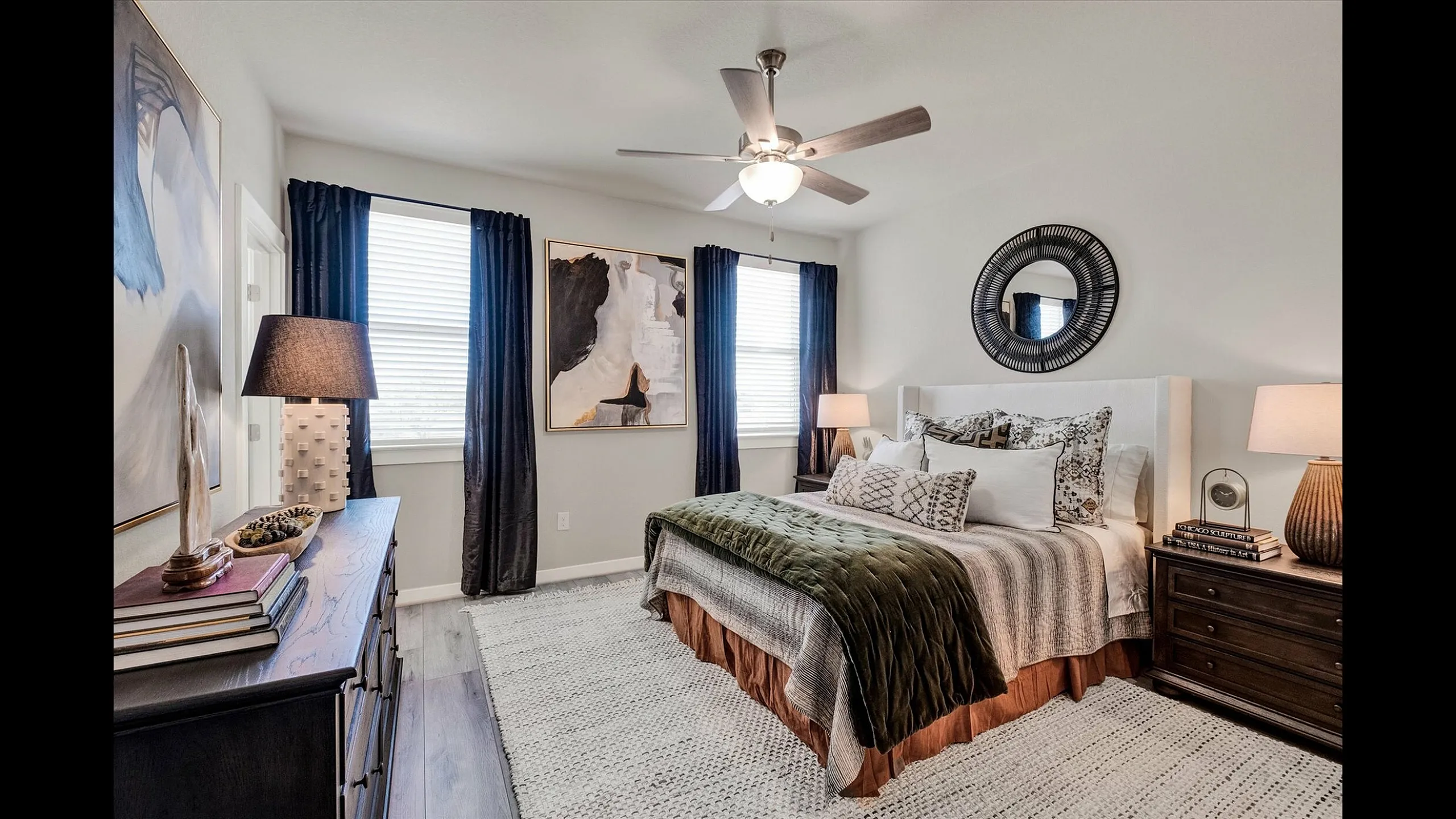 Elegantly furnished bedroom with modern decor, featuring a plush bed, stylish artwork, and ambient lighting, creating a cozy and inviting atmosphere.