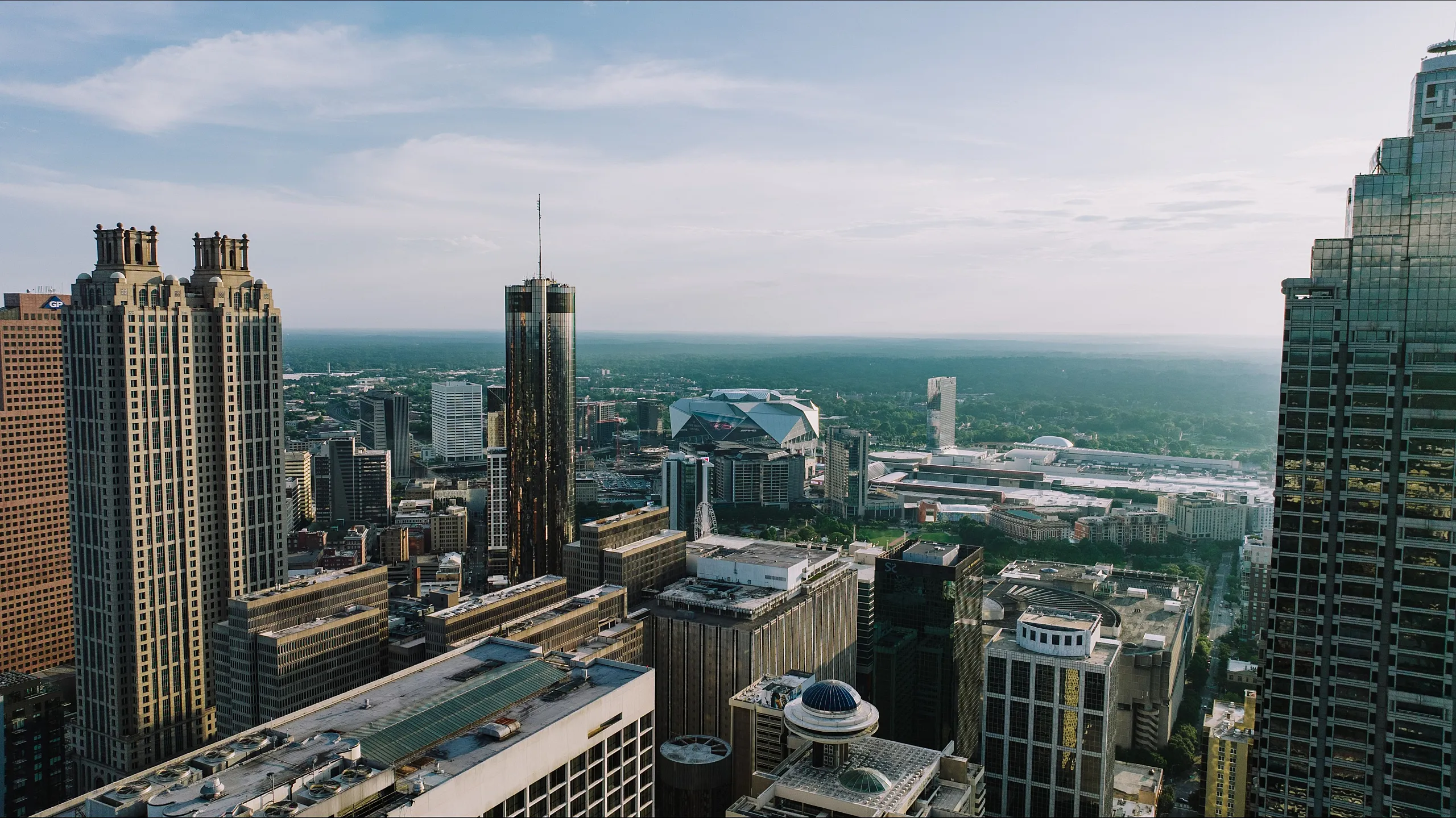 Breathtaking cityscape view showcasing towering skyscrapers and a sprawling urban landscape under a clear blue sky.