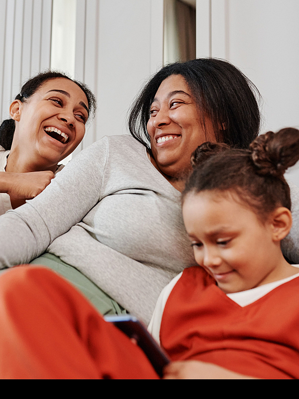 Joyful family moments in a cozy, modern living room with comfortable seating and warm ambiance.