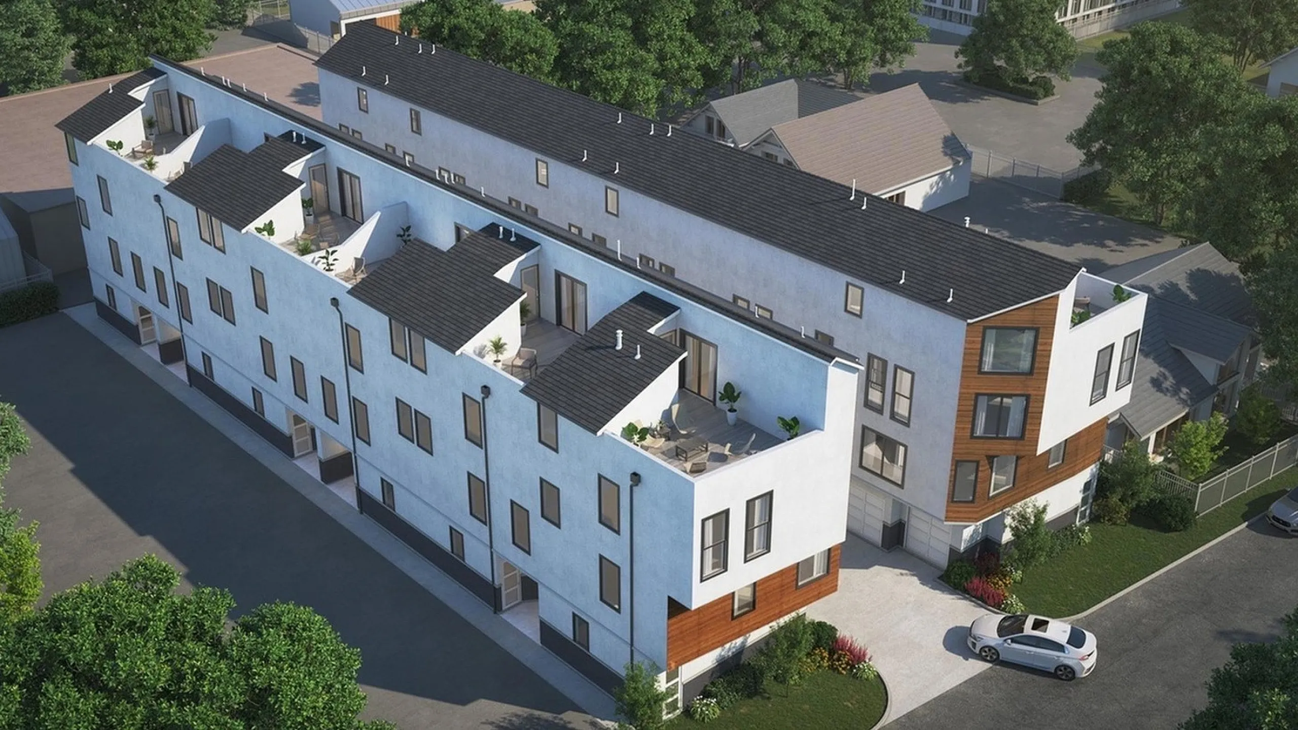 Modern apartment complex with a sleek design, featuring private rooftop patios and ample windows for natural light, set in a lush and green suburban neighborhood.