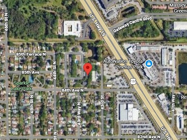 Vibrant aerial view of residential neighborhood near U.S. Highway 19, showcasing lush greenery and strategic proximity to amenities in Pinellas Park.