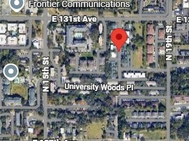 Satellite view highlighting a vibrant neighborhood with lush greenery, accessible roads, and proximity to amenities.