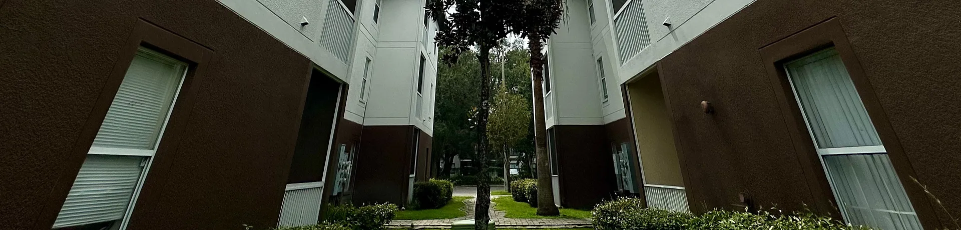 Chic modern apartment buildings with elegant architectural design and lush greenery.