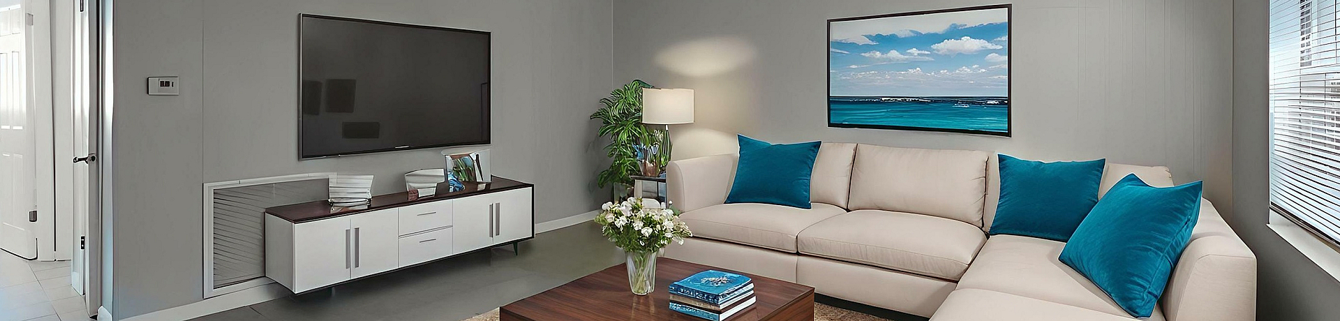 Chic living room showcasing a plush beige sectional, vibrant blue cushions, sleek TV setup, and abundant natural light.