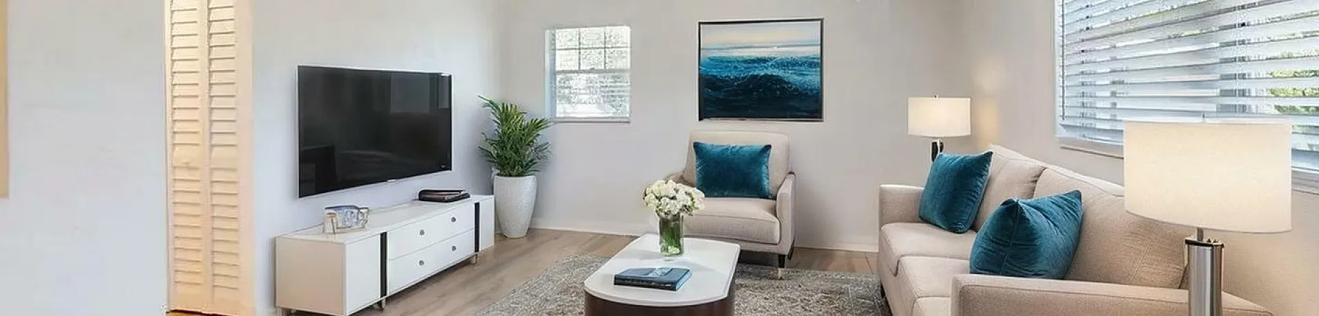 Bright and inviting living room with elegant furnishings, large windows, and modern decor, creating a cozy and stylish atmosphere.