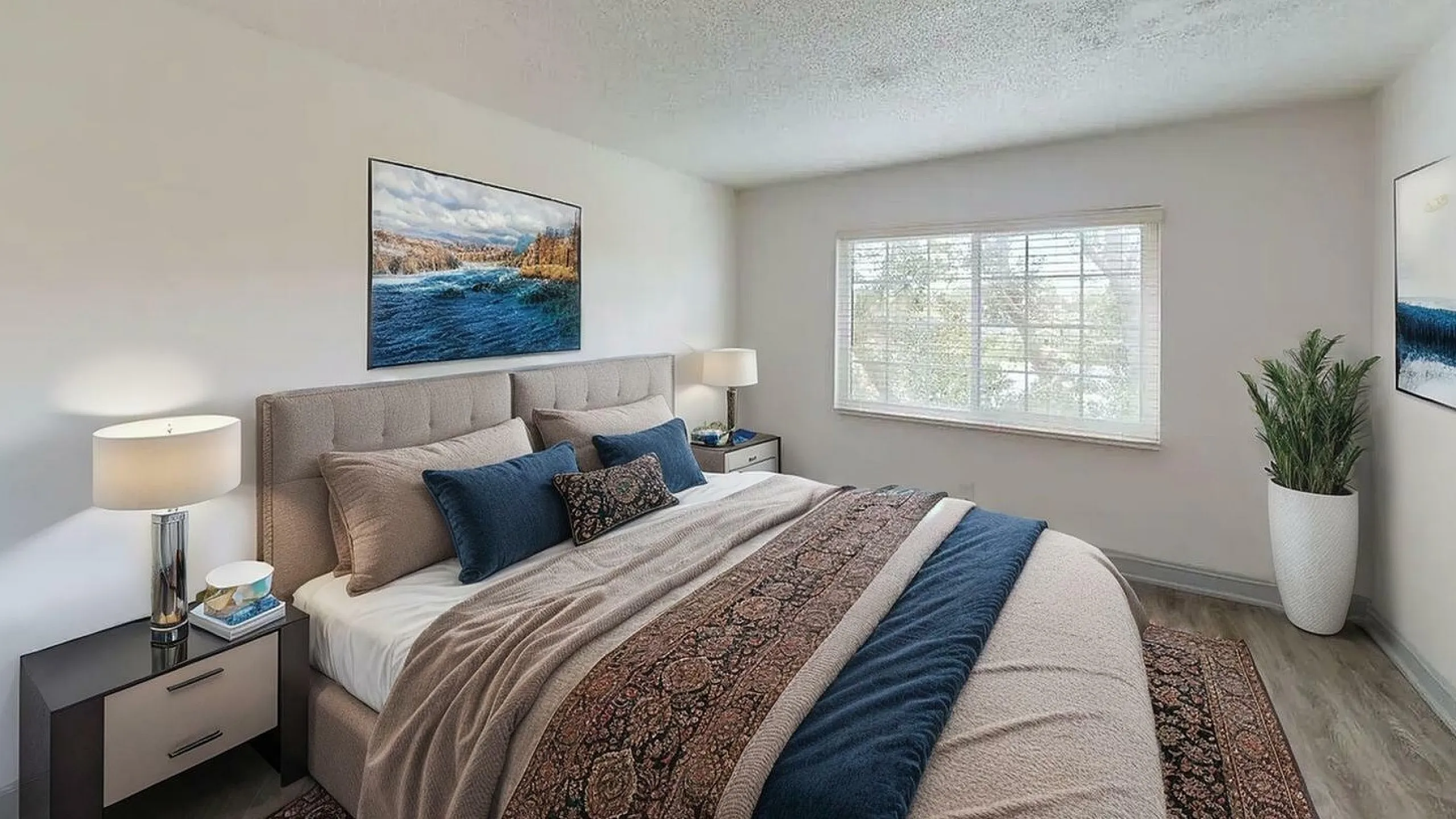 Bright and inviting bedroom with a plush bed, modern decor, and a large window offering natural light.