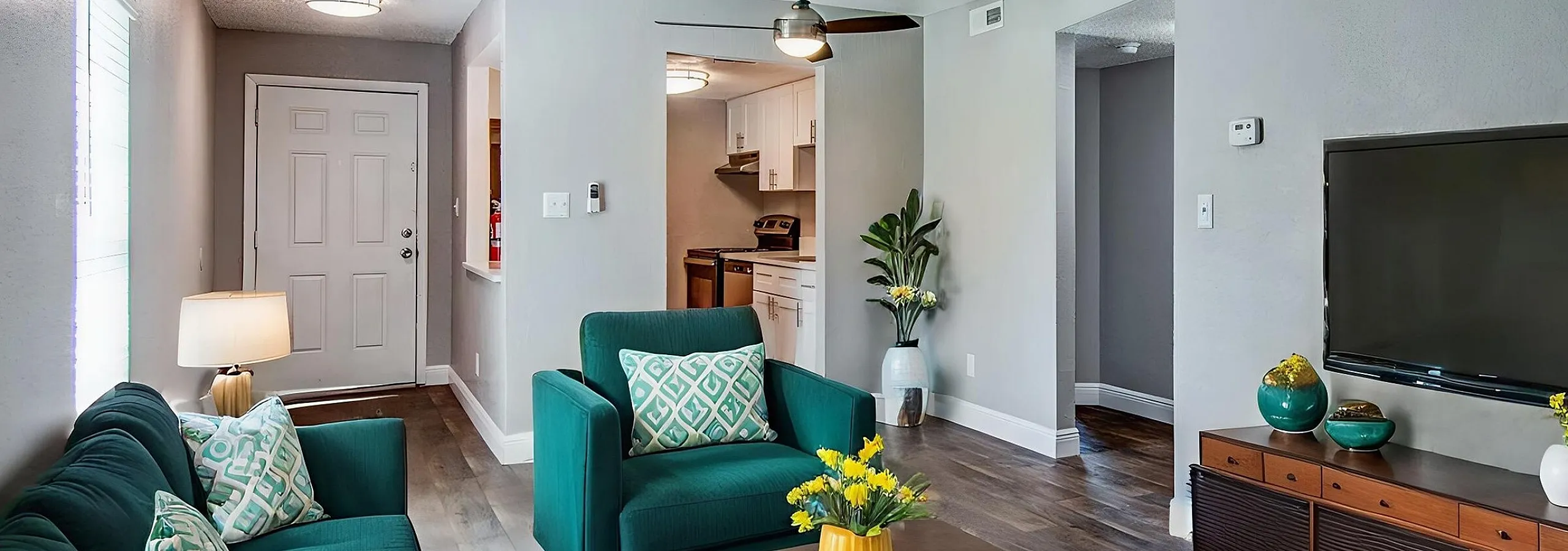 Modern living room featuring plush green seating, stylish decor, and a cozy ambiance with natural light.