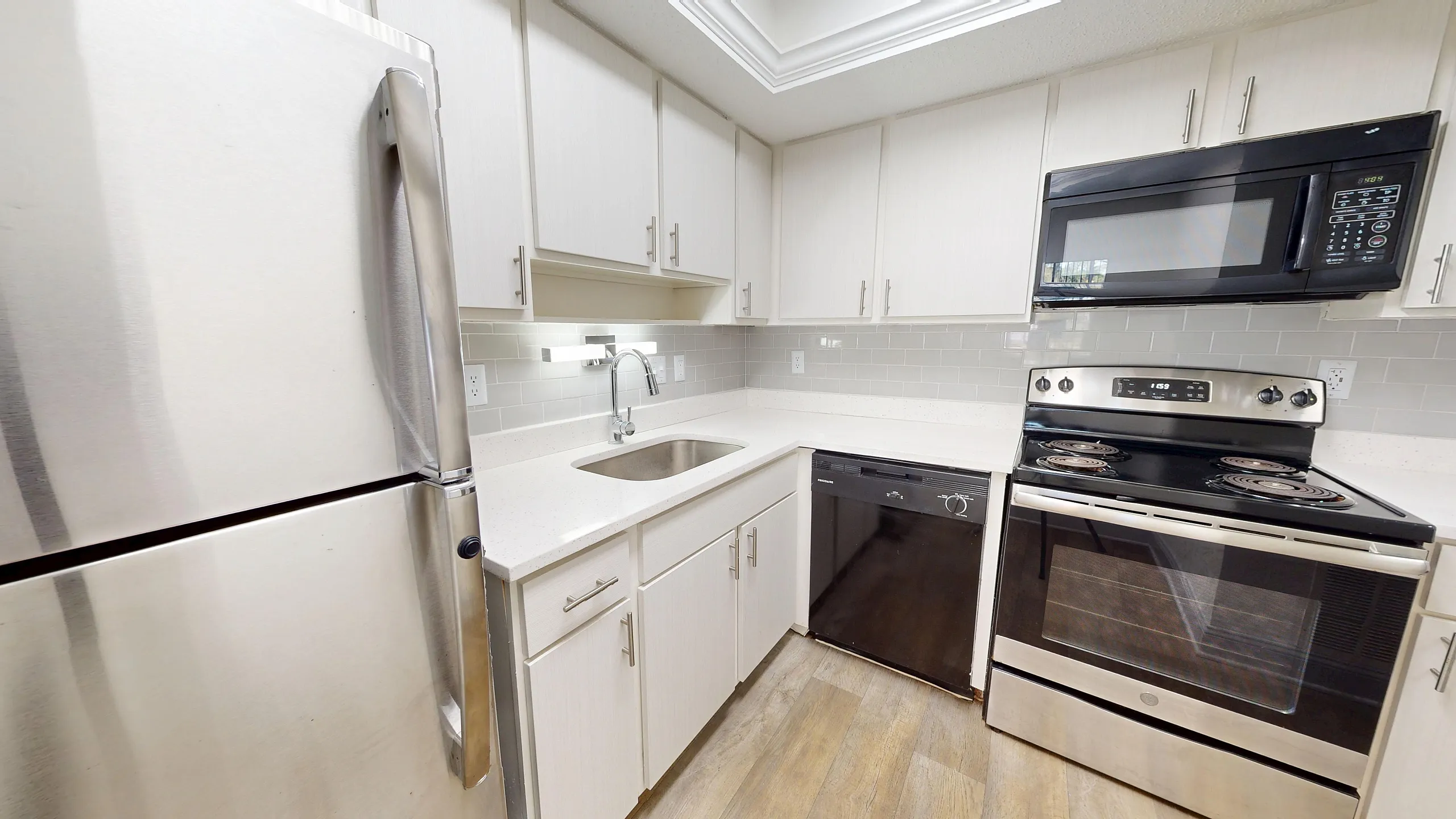 Modern kitchen with sleek stainless steel appliances, chic cabinetry, and gleaming countertops, offering a stylish and functional cooking space.