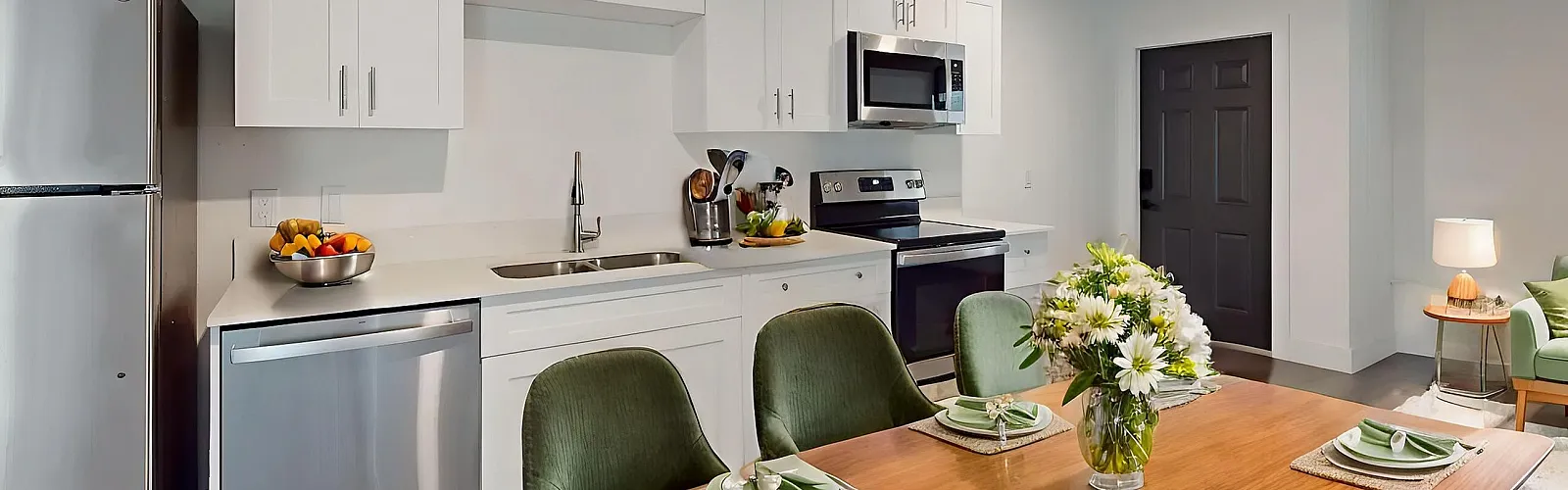 Contemporary open-concept kitchen and dining area with modern appliances, elegant green accents, and cozy living space.