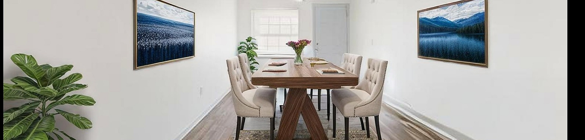 Elegant dining room with a modern wooden table, stylish chairs, and beautiful artwork on the walls, featuring warm wood flooring and abundant natural light.