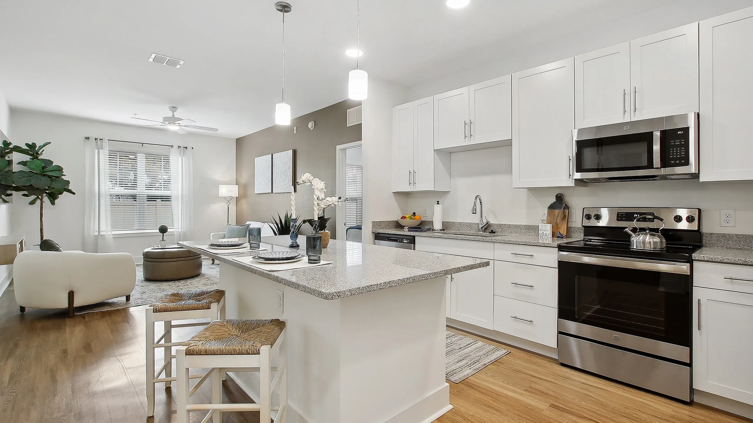Chic open-concept kitchen and living area with modern appliances, sleek countertops, and elegant decor.