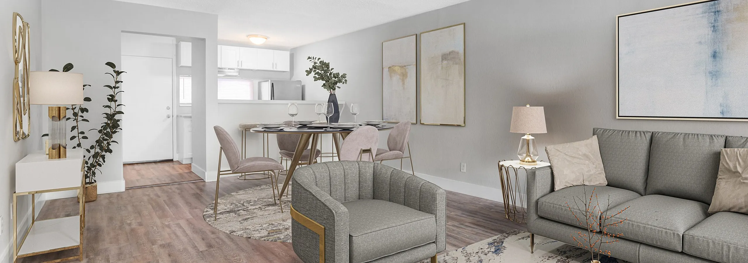 Stylish open-concept living and dining area with elegant furnishings, modern decor, and warm wooden flooring, leading to a sleek, contemporary kitchen.