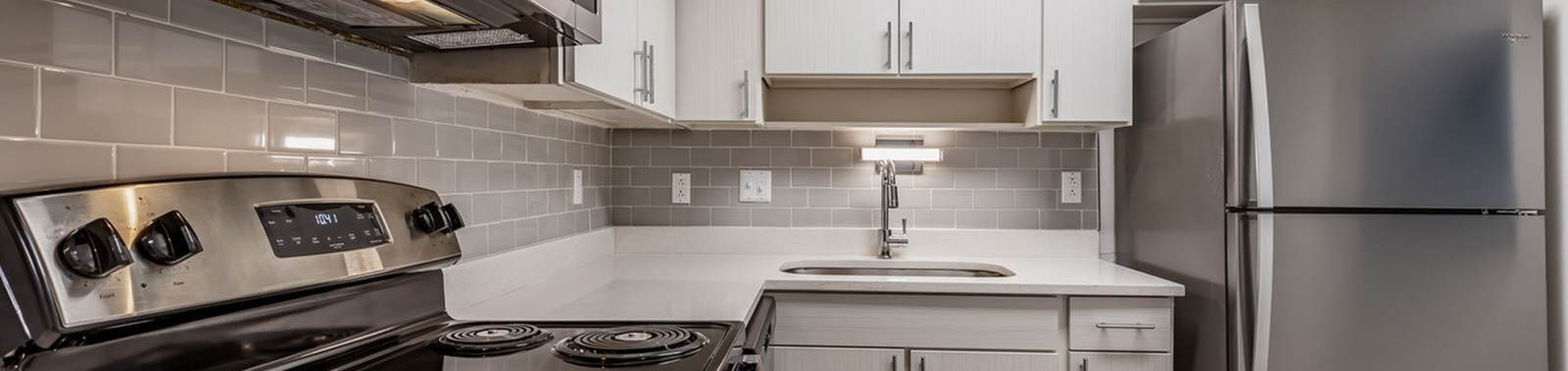 Renovated kitchen with stainless steel appliances in a Nordica Bay apartment