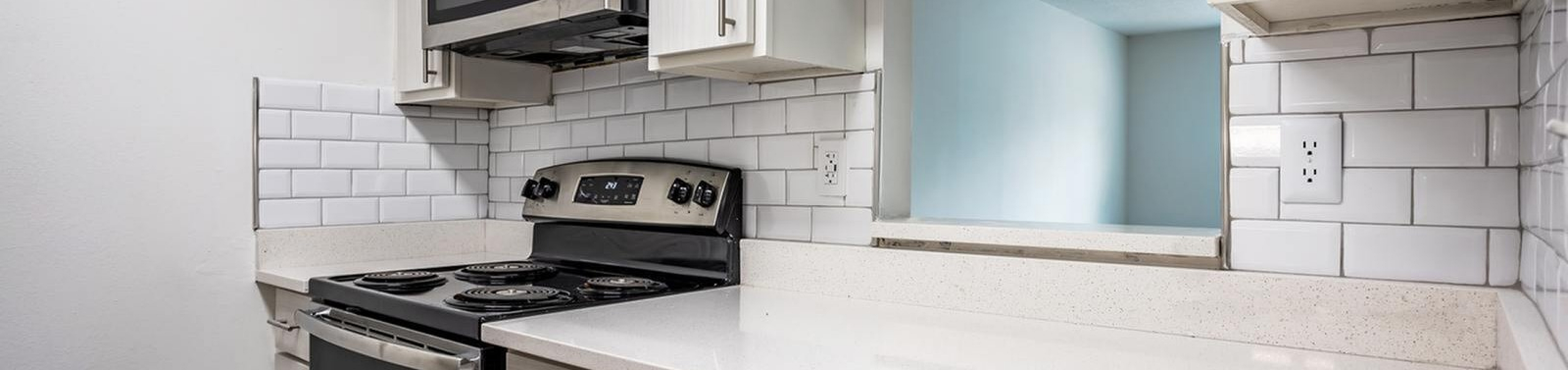 Renovated kitchen with white cabinets at Nordica Bay