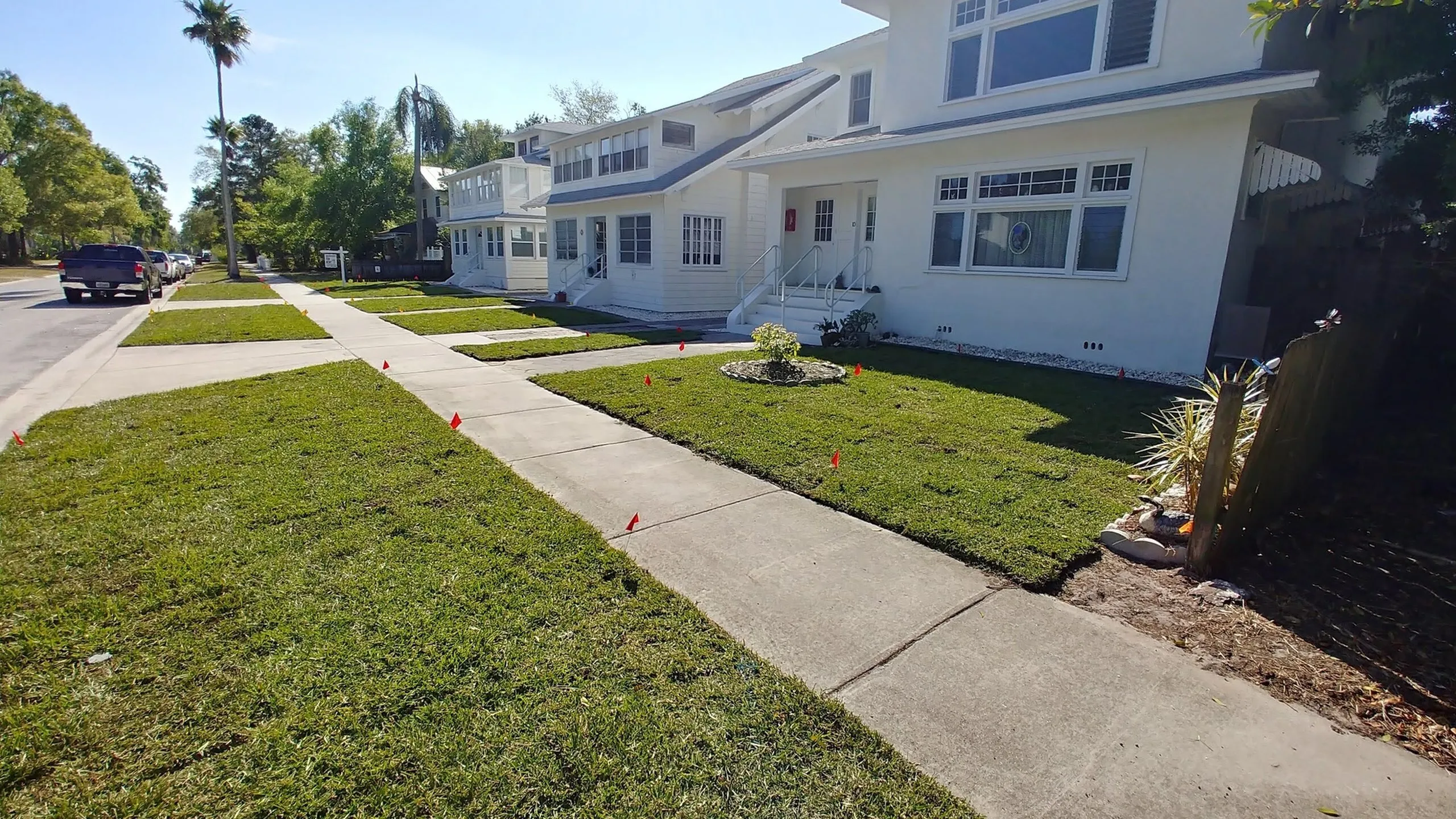Restored Nordica Village buildings along a sunny Allendale sidewalk