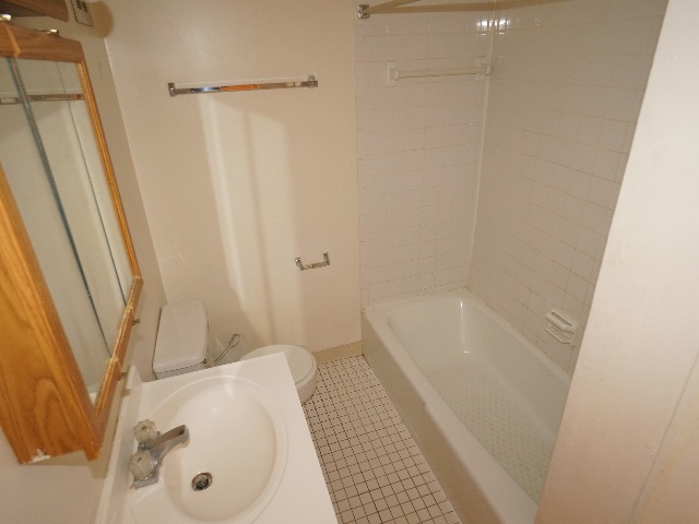 Talbot unit showing bathroom with cream colored walls, and white colored tile flooring. White bathtub, toilet, and sink.