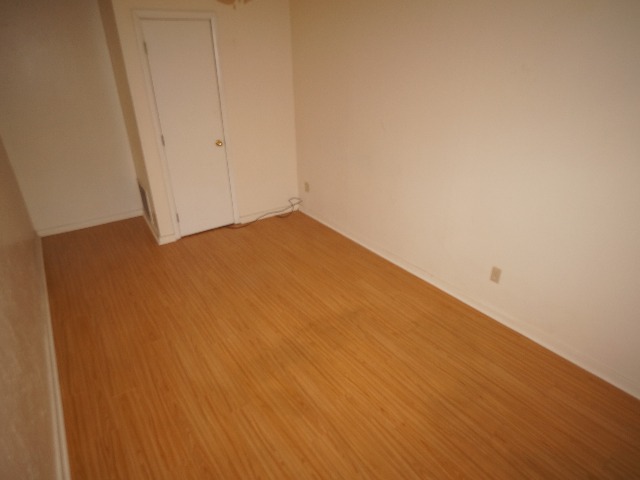 Talbot unit showing dressing room with cream colored walls, and hardwood vinyl flooring.