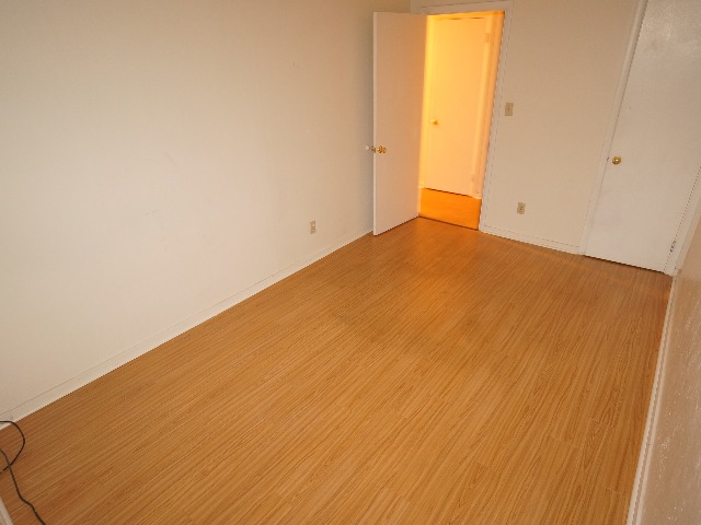 Talbot unit showing dressing room with cream colored walls, and hardwood vinyl flooring.